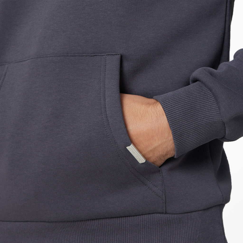 Close up shot of male hand in front pocket of dark grey hoodie